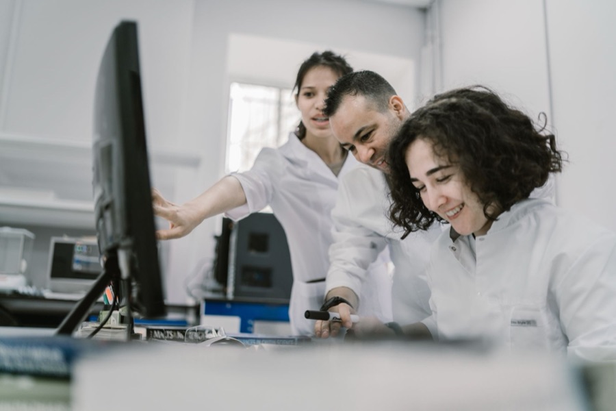 Research team reviewing scientific work on a screen